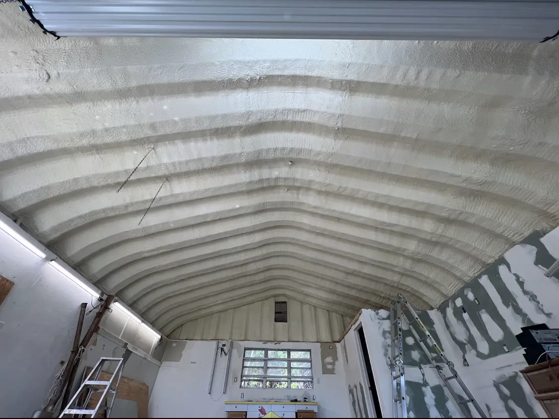 Spray polyurethane foam applied to the underside of a metal roof deck in Guilford